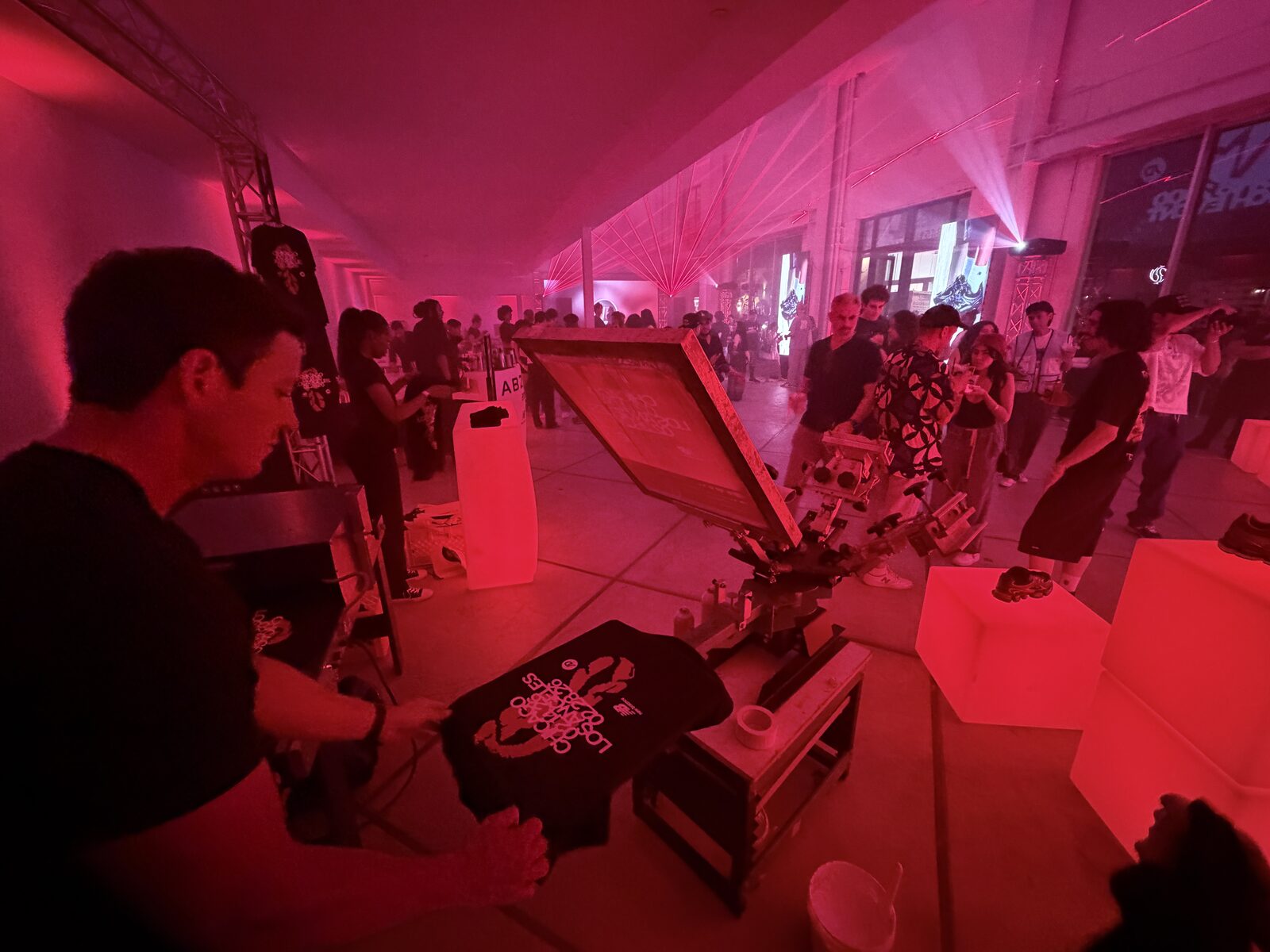 Guest holding a freshly pressed custom shirt at a party